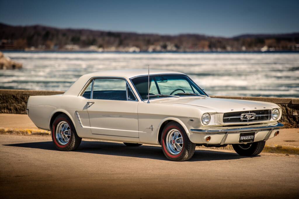 Classic white 1965 Ford Mustang parked at the beach