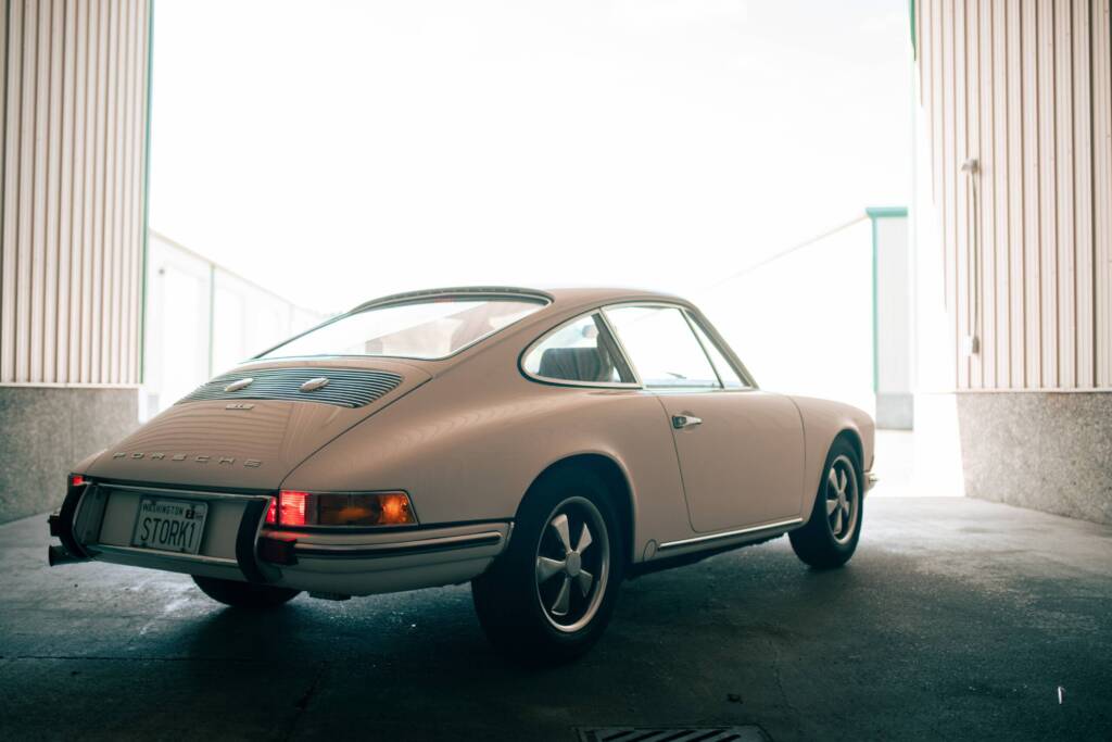 White 1969 Porsche 912 parked in between buildings