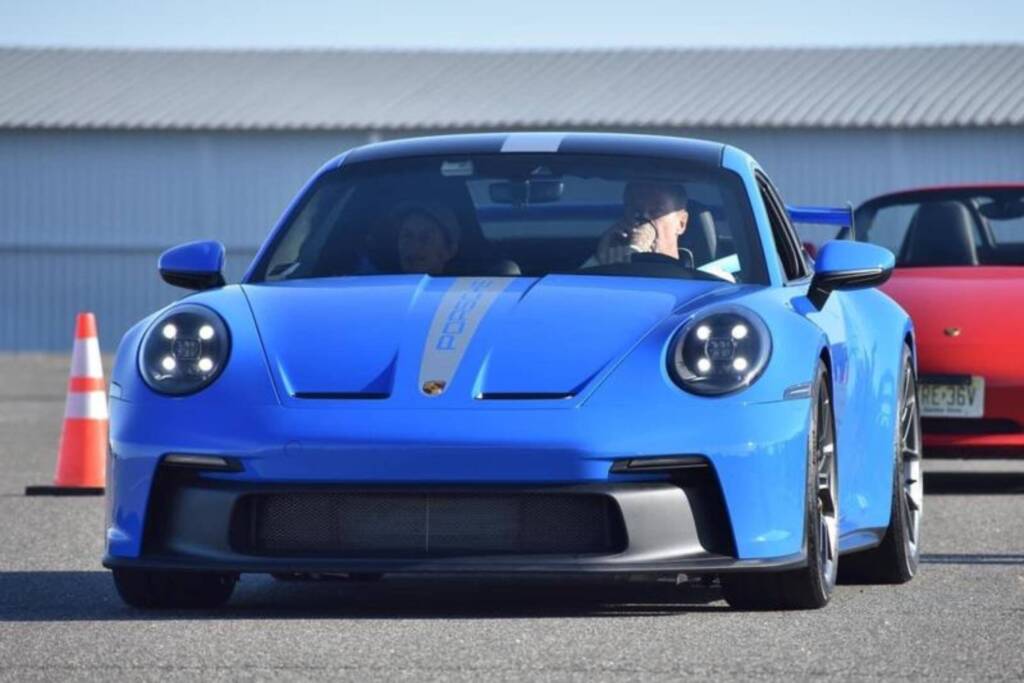 Blue 2022 Porsche 911 GT3 on the racetrack