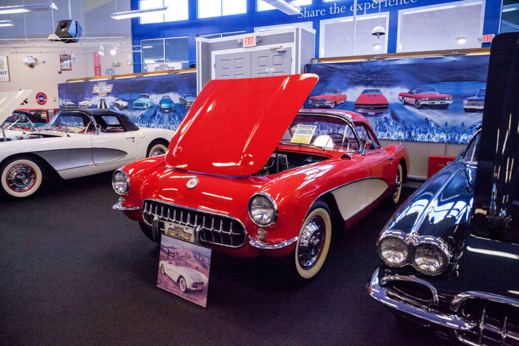 Red Corvette on display at a car auction