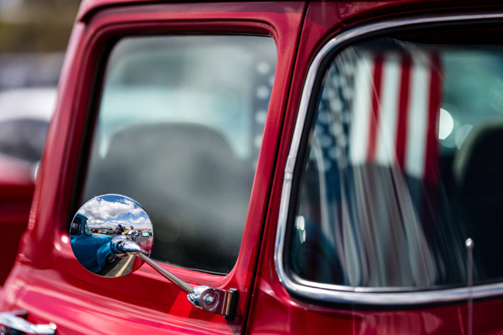 The United States flag inside Red pickup antique truck