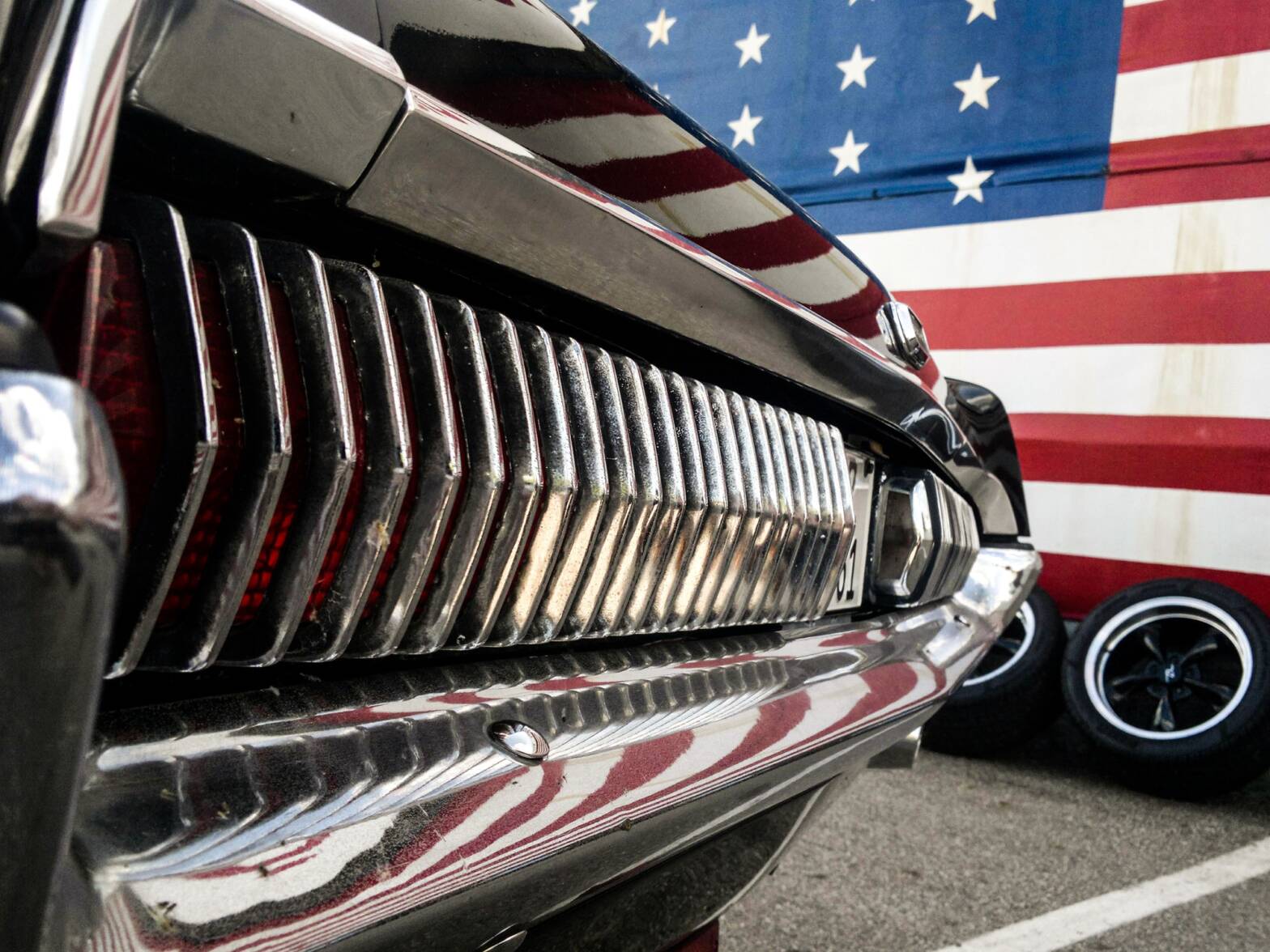 American muscle car near american flag