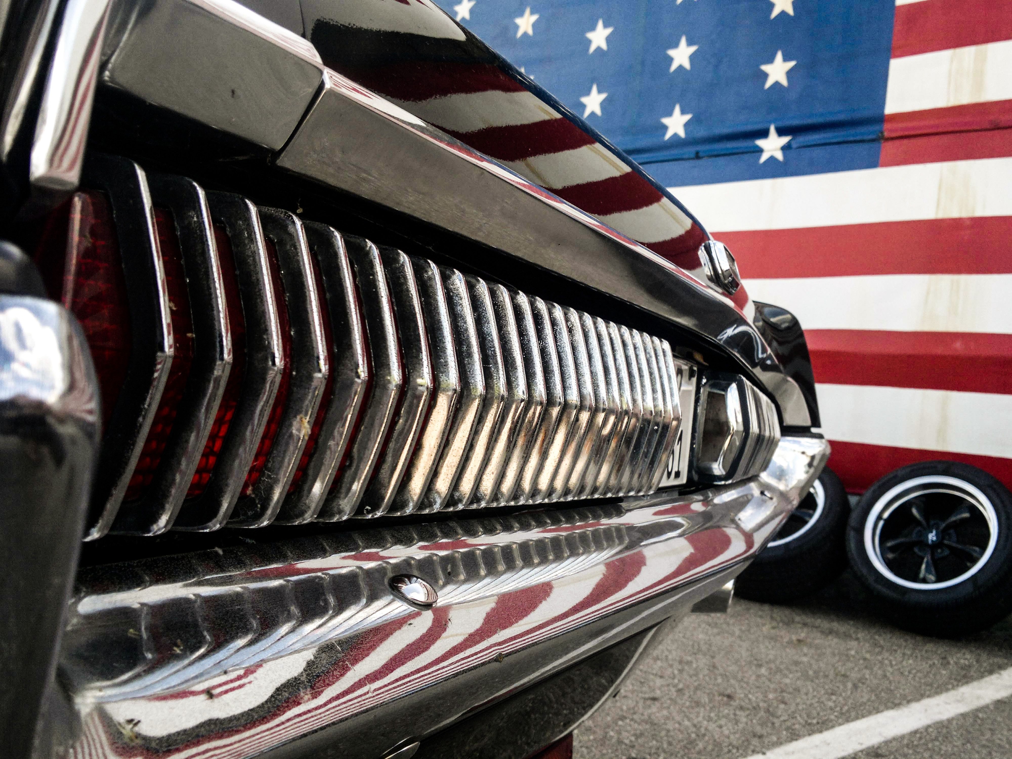 American muscle car near american flag