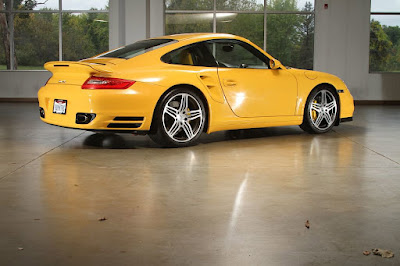 yellow Porsche parked in a garage
