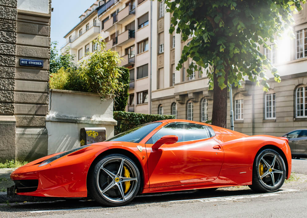 Red ferrari parked in the city