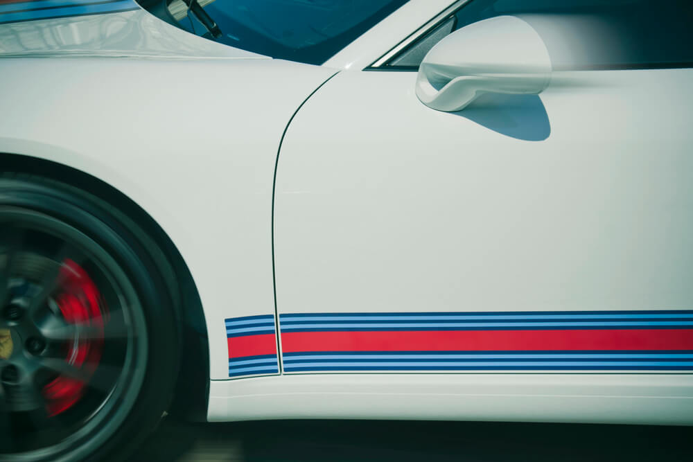 White Porsche with racing stripes