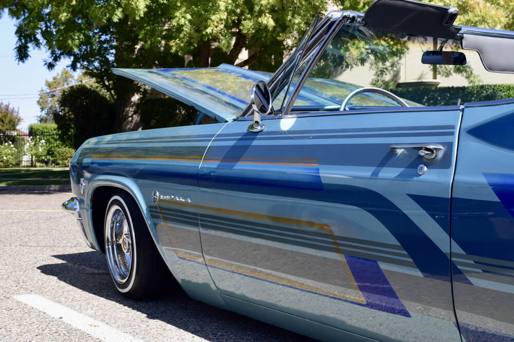 Blue chevy impala convertible with hood open 