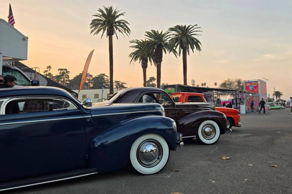 Black,. blue, and red classic cars parked at car show