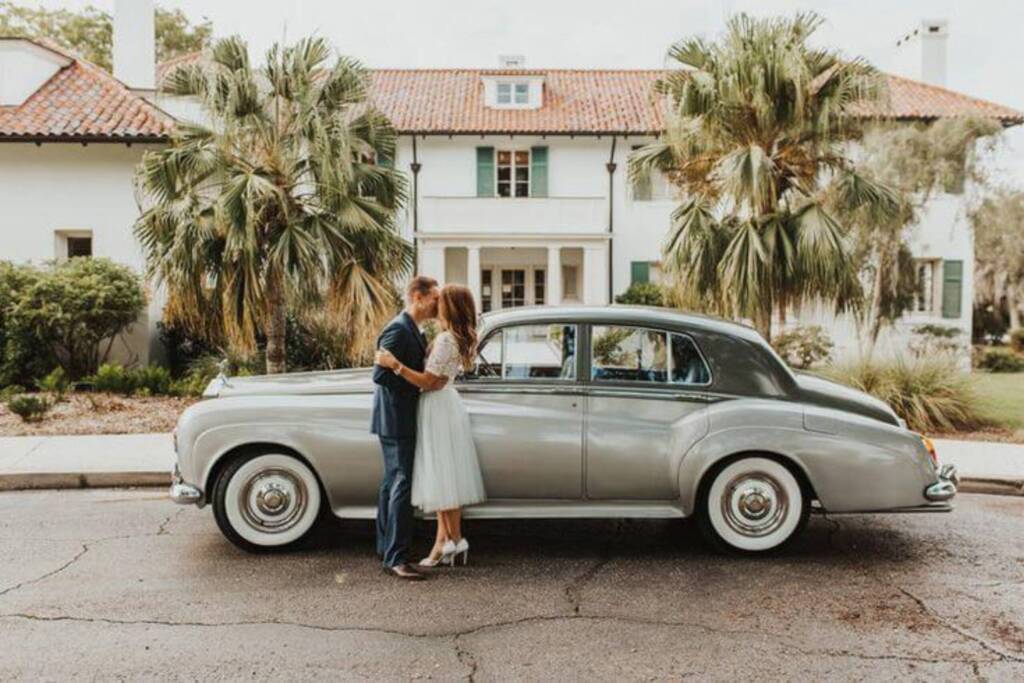 Vintage Rolls-Royce getaway car and newlyweds