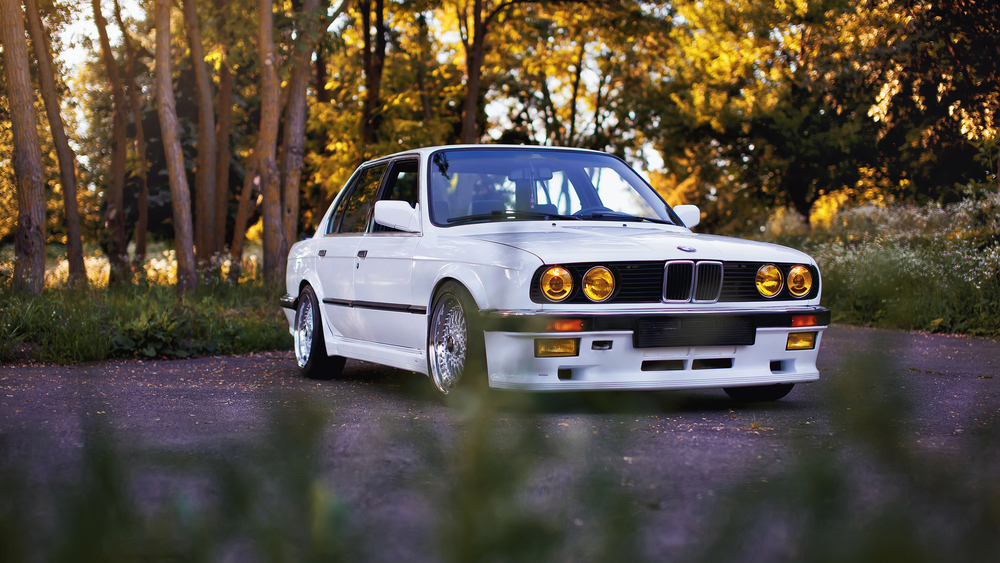 White classic BMW M3 e30 in the forest