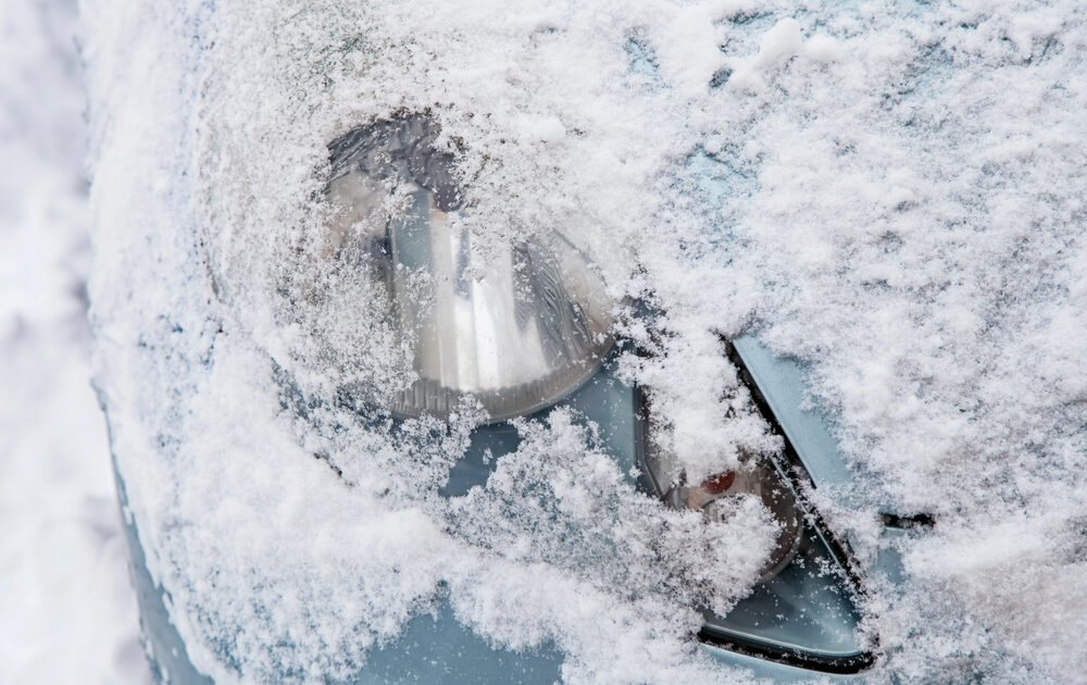 headlight of Porsche covered in snow