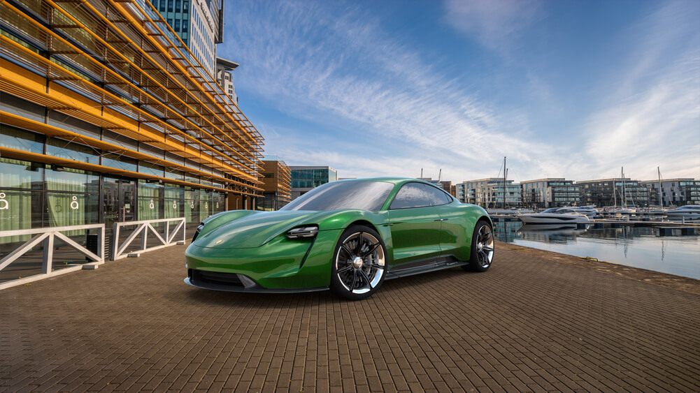 green Porsche parked near marina
