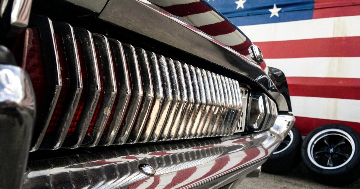 American muscle car near american flag