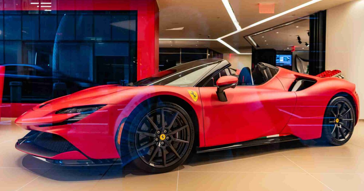 Cherry red Corvette parked outside of a Chevrolet dealership