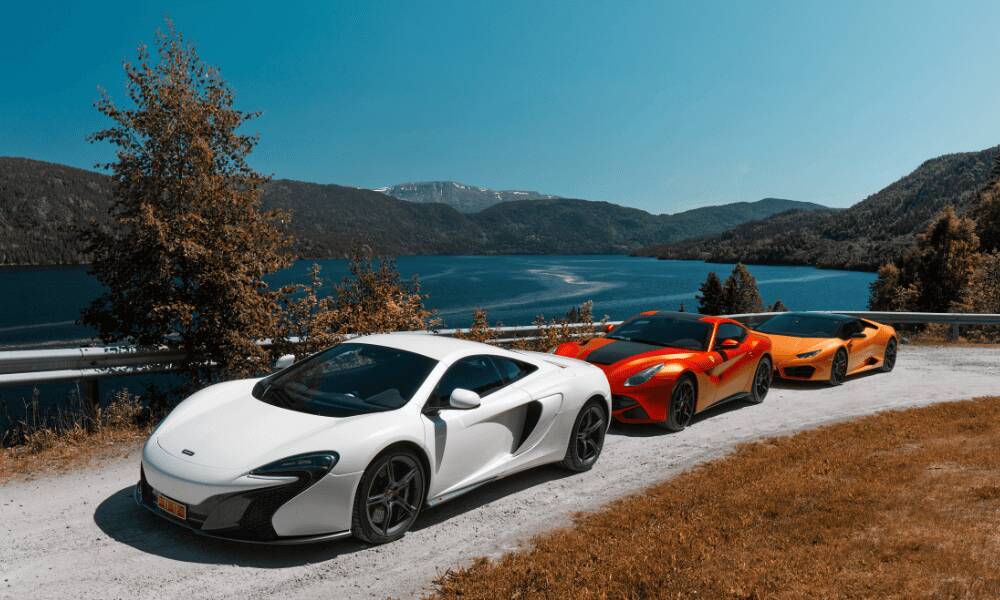 exotic car driving down coastal road